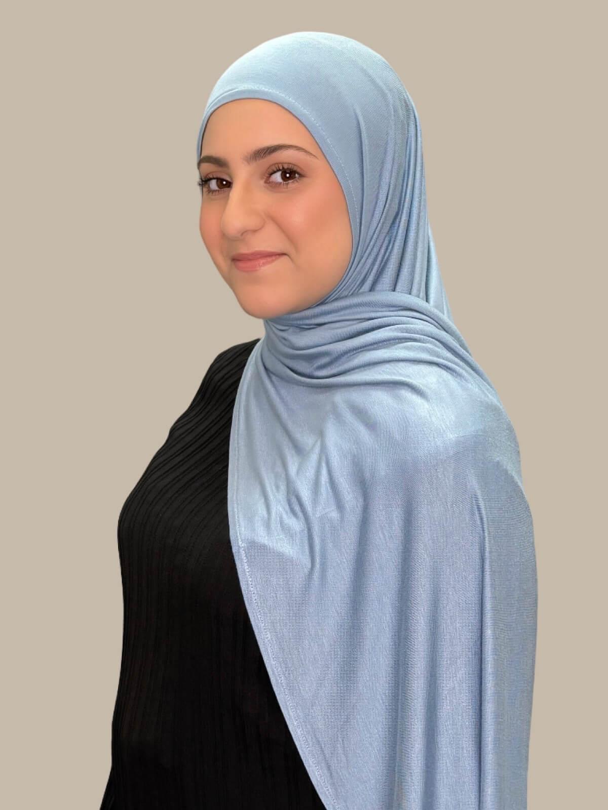 Dusty Blue Pre-Sewn Jersey Hijab in Modish Girl size, side view on model with hijab draped over shoulder showing smooth fit and soft stretch fabric.