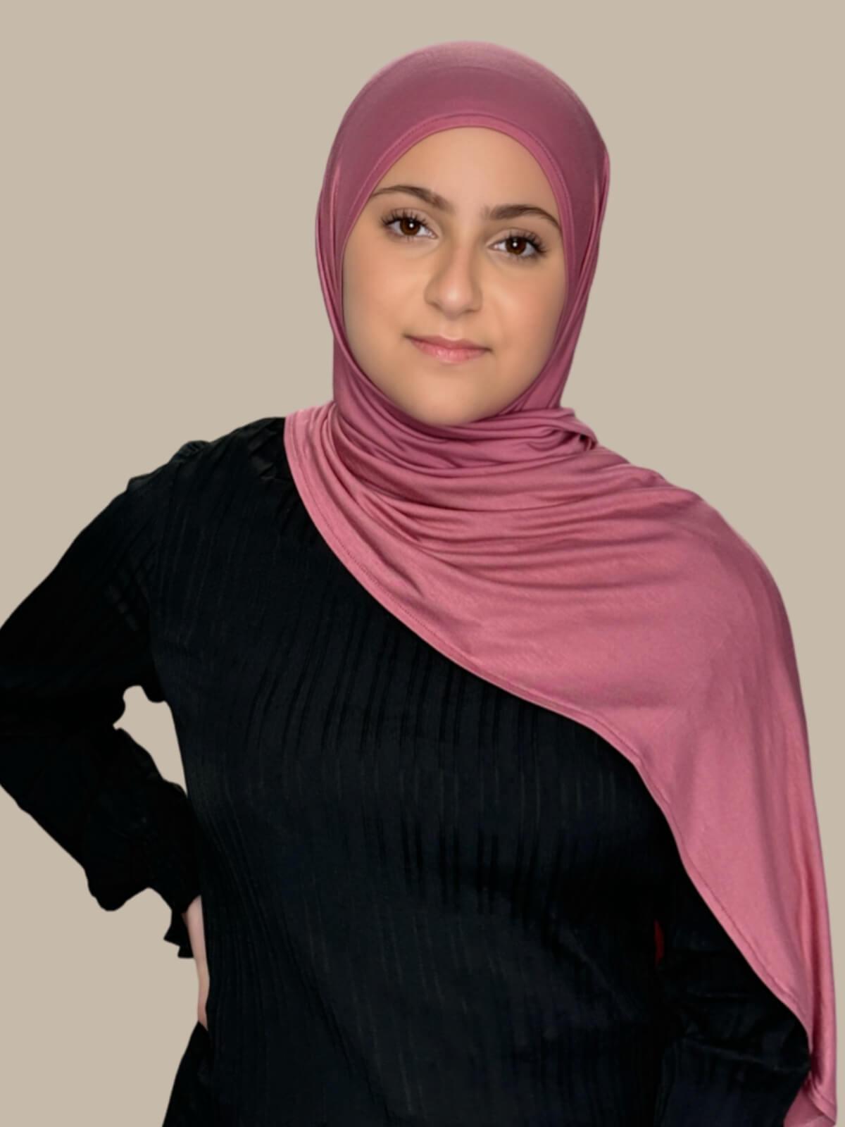 Pale Rose Pre-Sewn Jersey Hijab in Modish Girl size, front view on model with hijab draped over shoulder