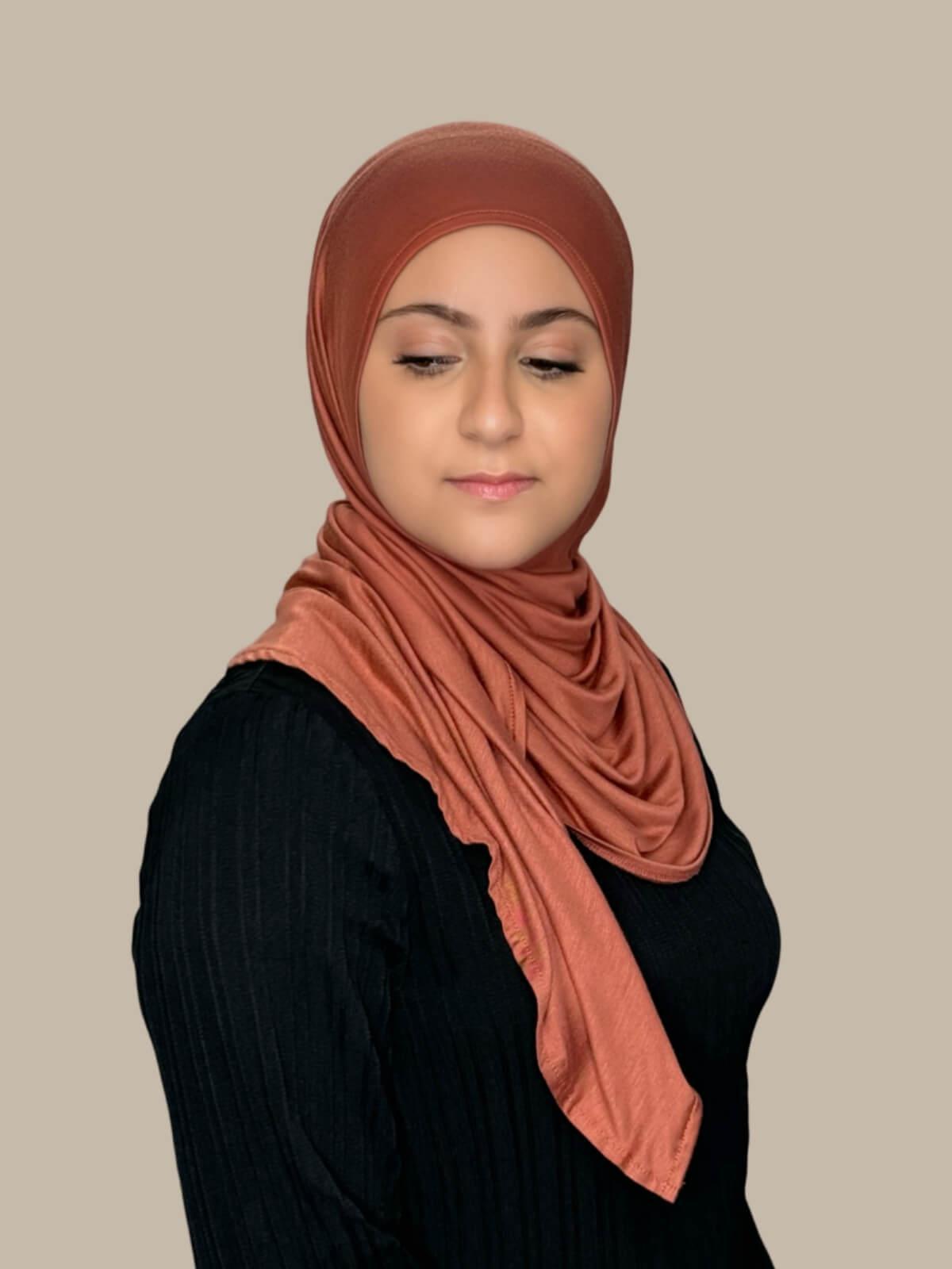 Brick Red Pre-Sewn Jersey Hijab in Modish Girl size, side view on model with hijab wrapped neatly around shoulders showing smooth fit and soft stretch fabric.