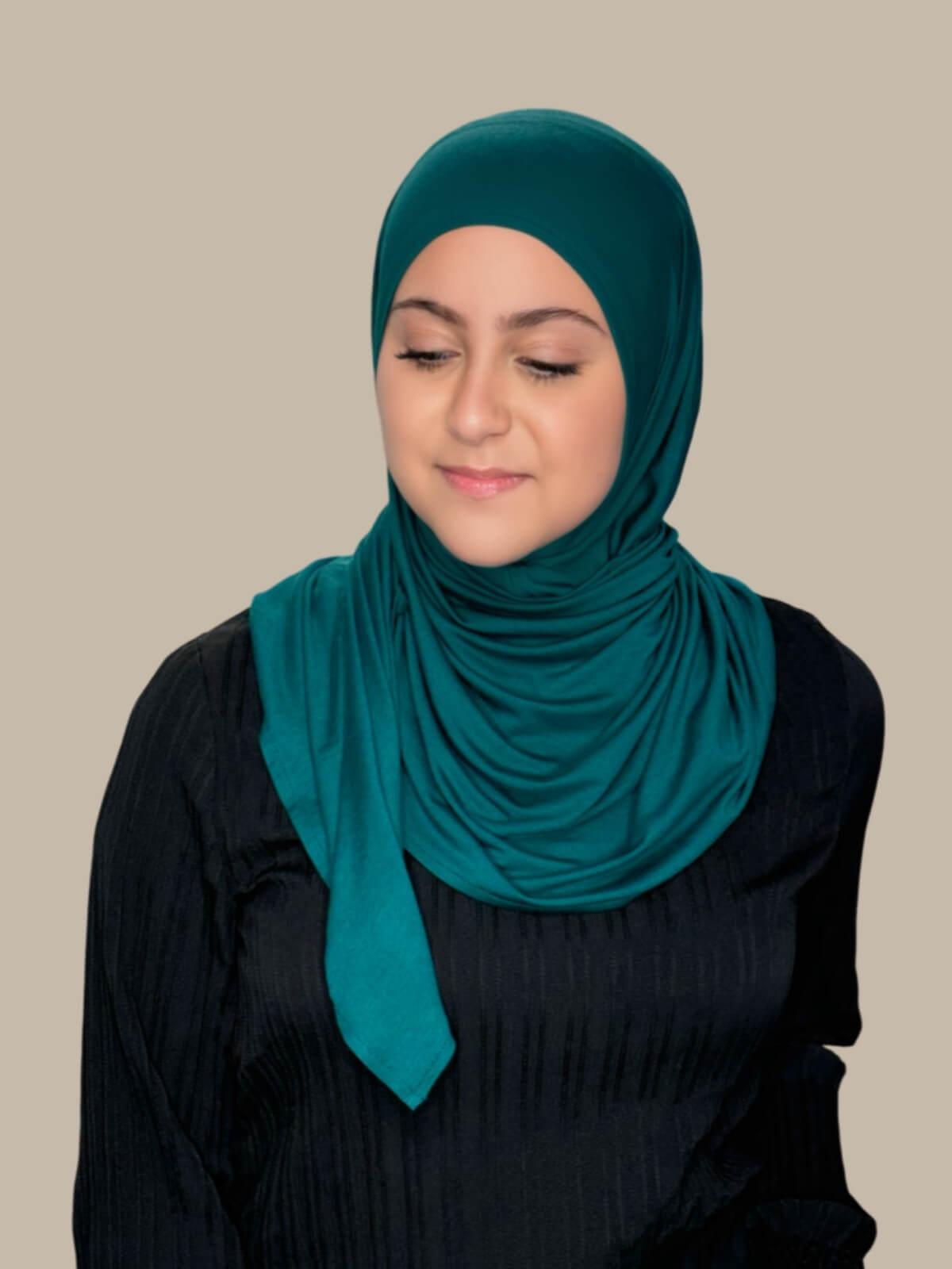 Pine Green Pre-Sewn Jersey Hijab in Modish Girl size, front view on model with hijab wrapped neatly around shoulders showing smooth fit and soft stretch fabric. No pins effortless