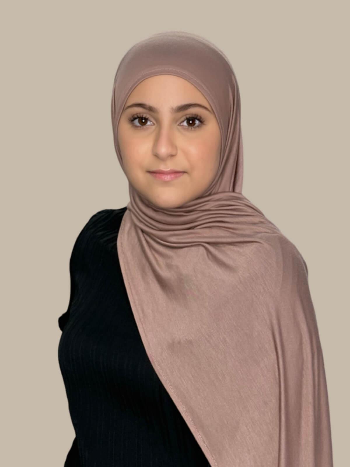 Pale Taupe Pre-Sewn Jersey Hijab in Modish Girl size, side view on model with hijab draped over shoulder showing smooth fit and soft stretch fabric.