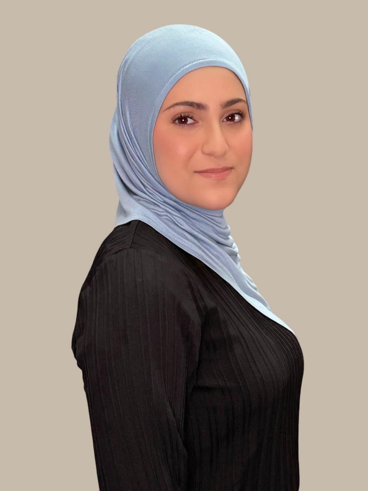 Dusty Blue Pre-Sewn Jersey Hijab in Modish Girl size, side view on model with hijab draped over shoulder 