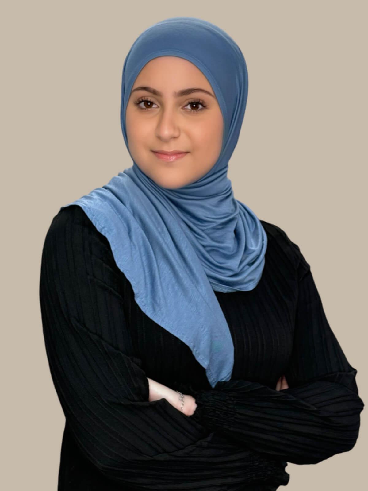 Blue Grey Pre-Sewn Jersey Hijab in Modish Girl size, front view on model with hijab wrapped neatly around shoulders showing smooth fit and soft stretch fabric. No pins effortless